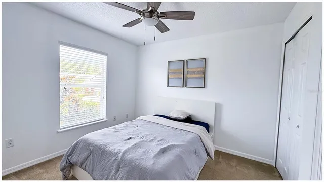 a bedroom with a bed and a window