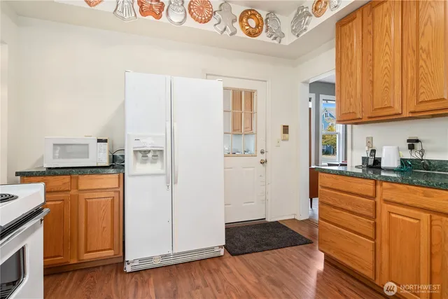 a kitchen with stainless steel appliances granite countertop a refrigerator and microwave