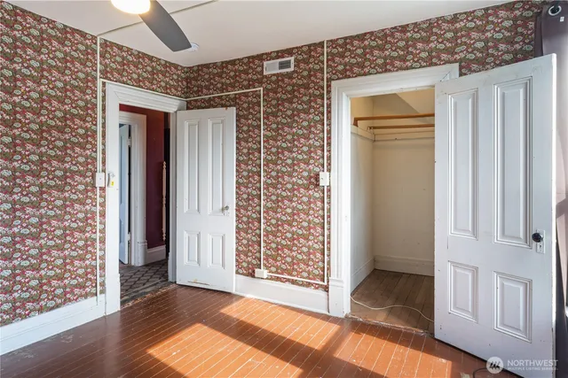 a bathroom with a granite countertop sink mirror vanity and toilet