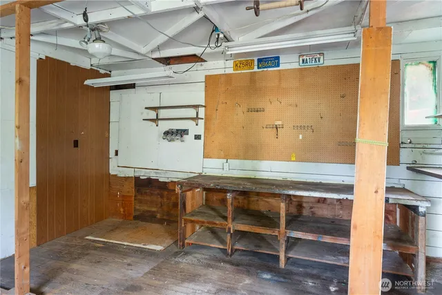 a view of a house with a small yard and wooden floor and fence