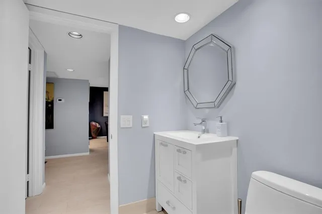 a bathroom with a sink toilet and a mirror
