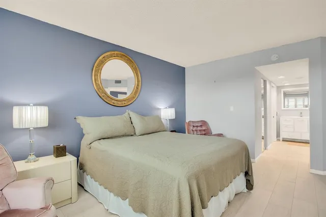 a bedroom with a bed and a lamp