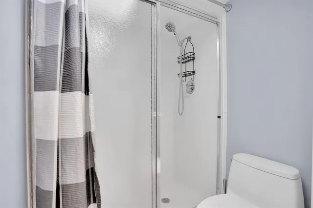 a bathroom with a shower and toilet