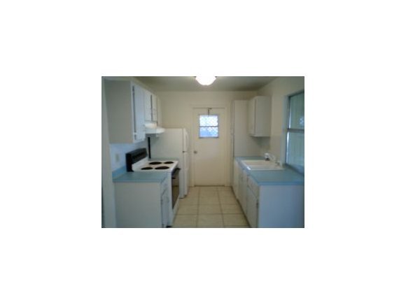 3291 Northeast Fairfax Palm Bay, FL 32905 - Photo 3 of 12 a bathroom with a sink and a mirror