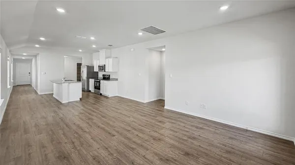 a view of a kitchen with a sink and a refrigerator