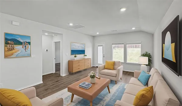 a living room with furniture kitchen view and a window