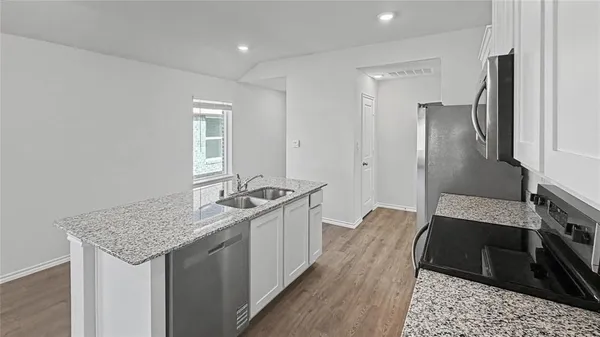 a kitchen with a sink stove and refrigerator