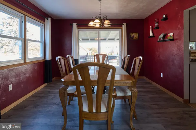 a view of a dining room with furniture wooden floor and chandelier
