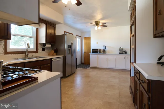 a kitchen with a sink appliances and cabinets