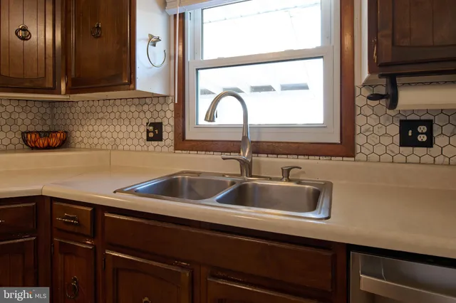 a close view of a sink a faucet and a cabinet in a kitchen