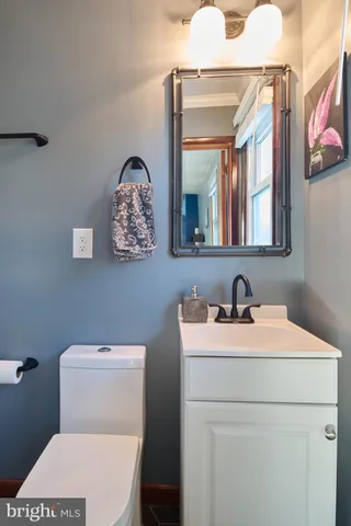 an empty room with windows and refrigerator