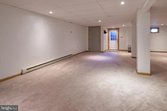 a bed sitting in a room next to a window