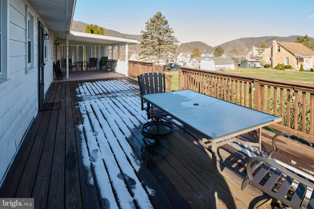 a view of a house with a yard and wooden fence