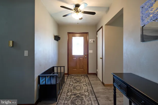 a view of hallway with furniture and a window