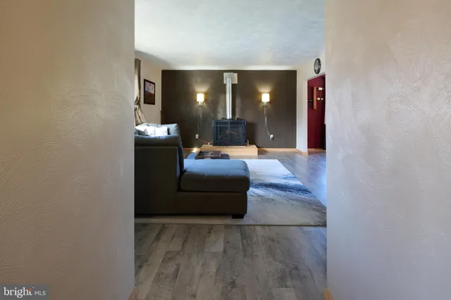 a living room with furniture and a lamp