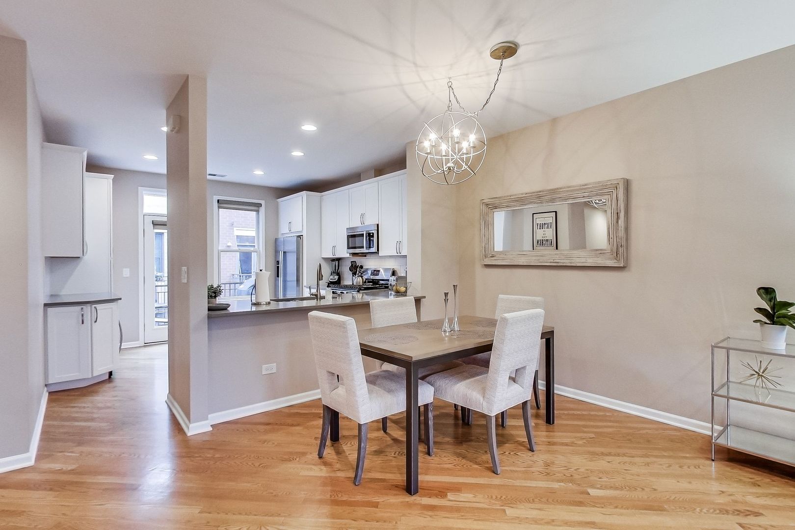 640 West Oak Street Chicago, IL 60610 - Photo 14 of 43 a view of a dining room and livingroom with furniture wooden floor a chandelier