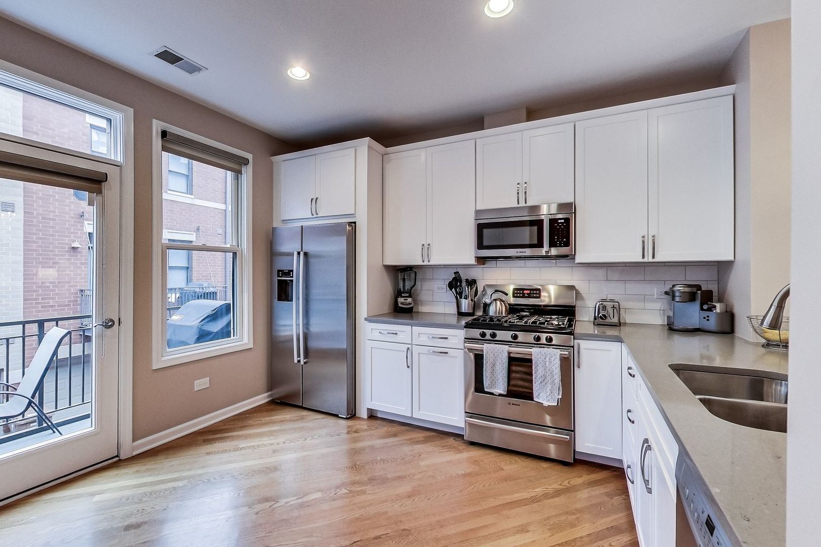 640 West Oak Street Chicago, IL 60610 - Photo 16 of 43 a kitchen with stainless steel appliances granite countertop a stove a sink and a refrigerator