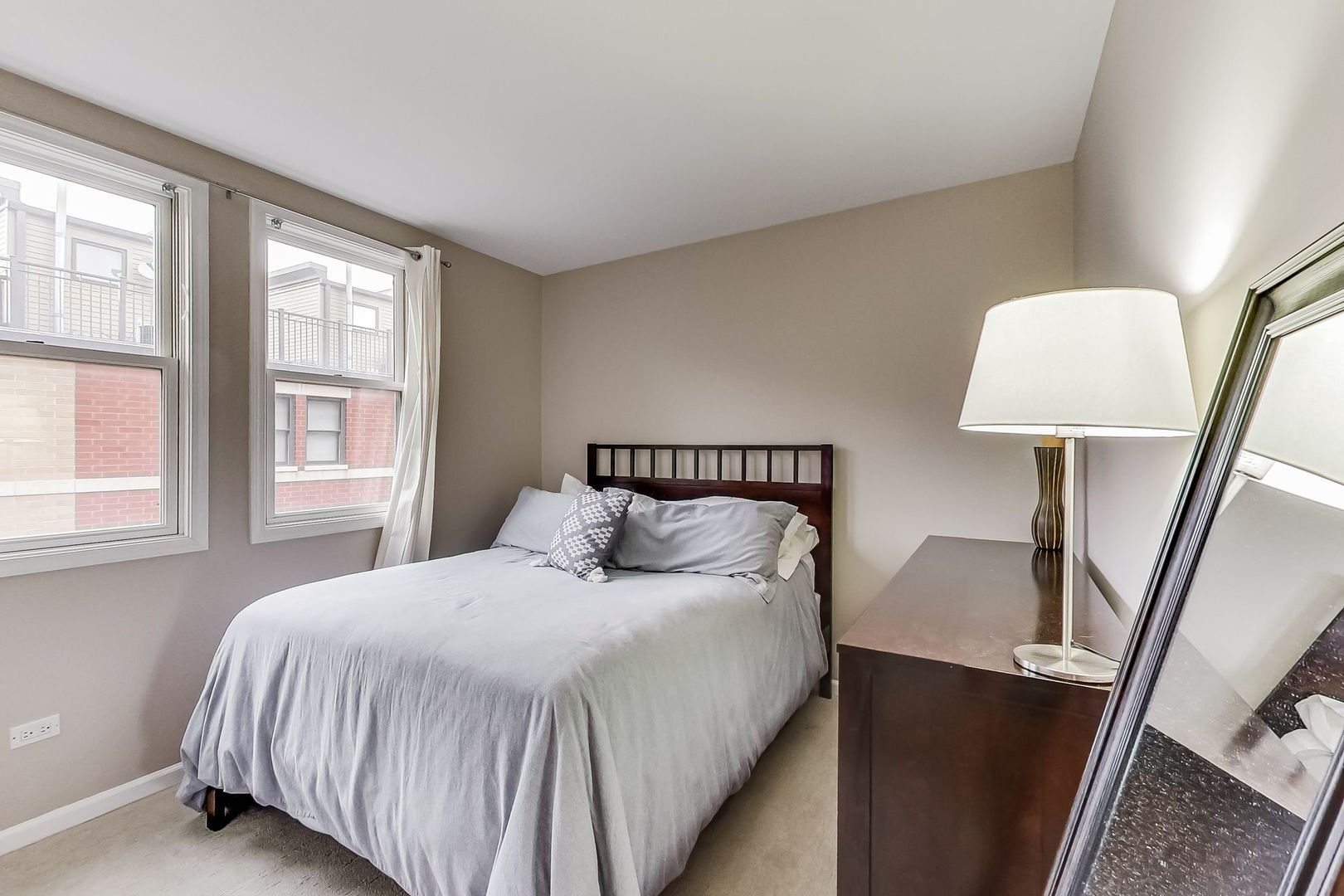 640 West Oak Street Chicago, IL 60610 - Photo 26 of 43 a bedroom with a bed and a lamp on table next to a window