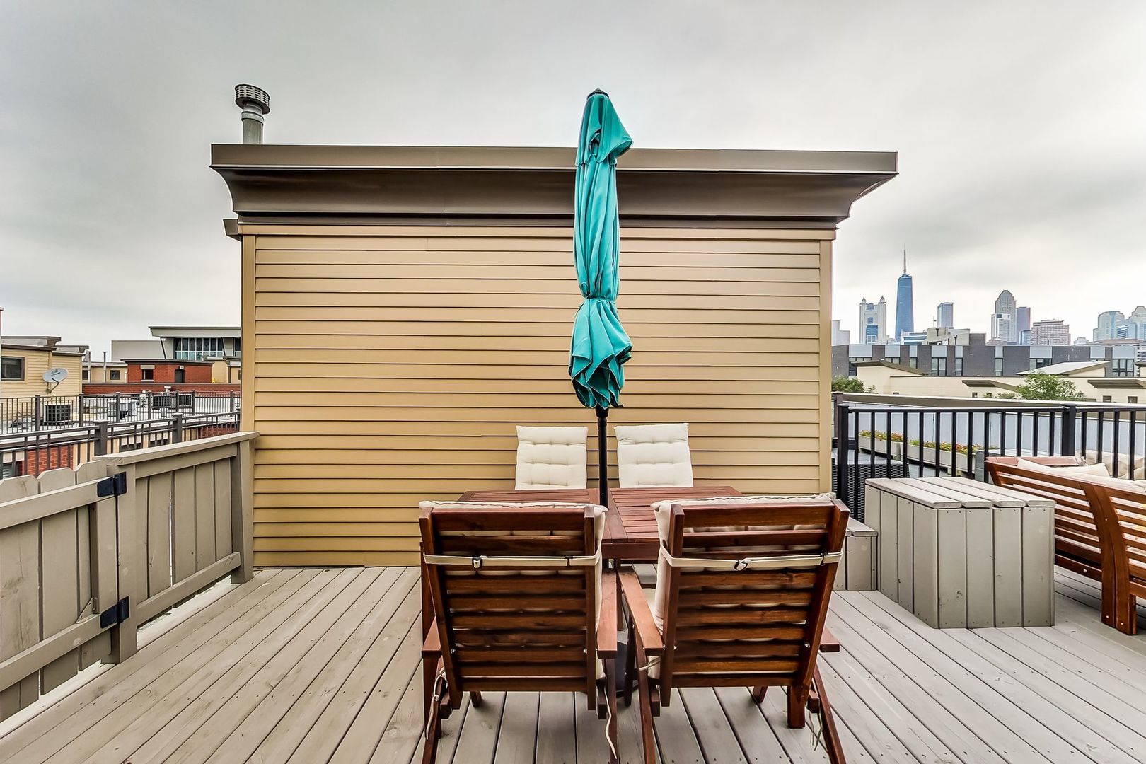 640 West Oak Street Chicago, IL 60610 - Photo 33 of 43 a view of a roof deck with wooden floor and fence