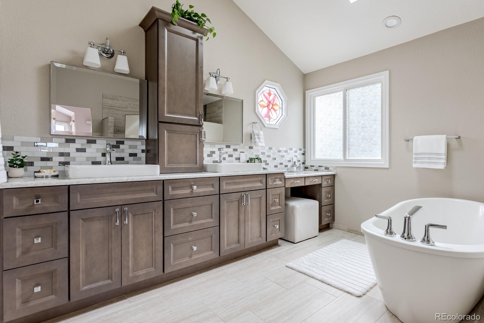 1914 Terrace Drive Highlands Ranch, CO 80126 - Photo 20 of 47 a bathroom with a tub sink and mirror