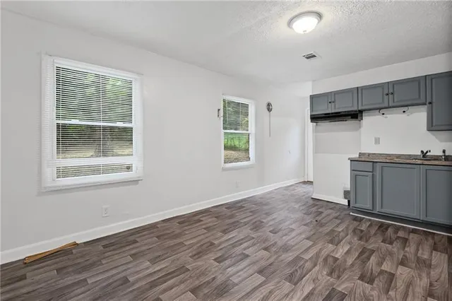 a view of a kitchen with a wooden floor and a window