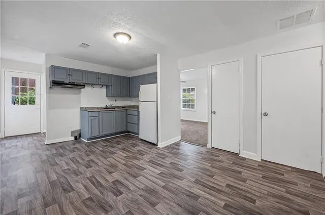 a view of kitchen with granite countertop cabinets and wooden floor