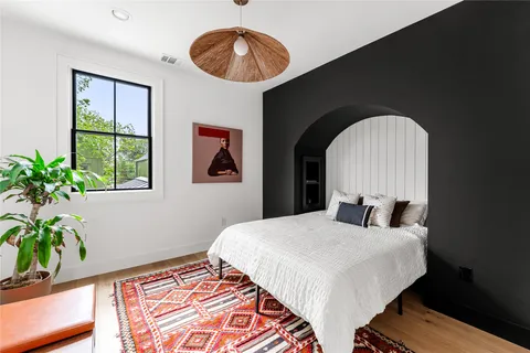 a bedroom with a bed and a potted plant