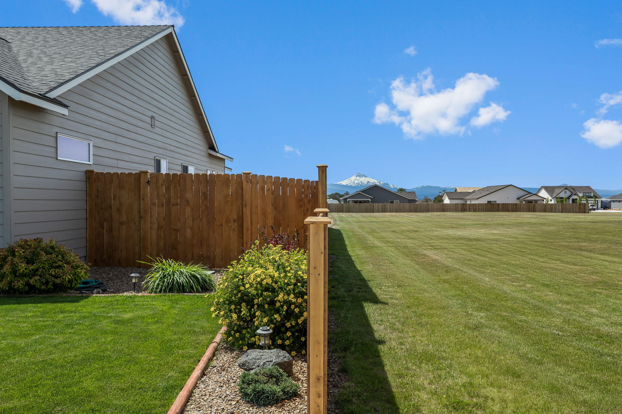 1132 Northwest Golf Course Drive Madras, OR 97741 - Photo 29 of 36 a view of a house with a garden