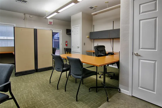 a dining room with furniture and kitchen view