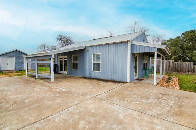 a view of a house with backyard porch and sitting area