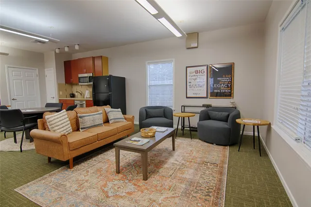 a living room with furniture and a rug