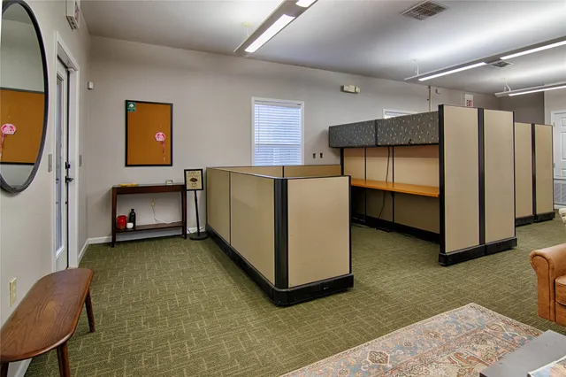 a view of a livingroom with furniture and a window