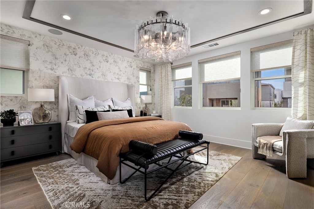 136 Creation Irvine, CA 92618 - Photo 8 of 18 a bedroom with a bed and a chandelier