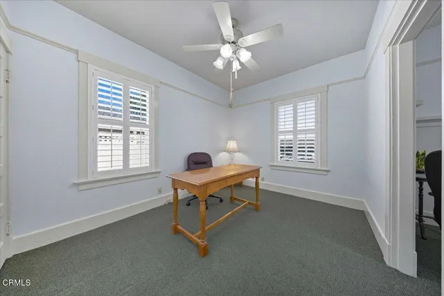 a work room with windows and furniture