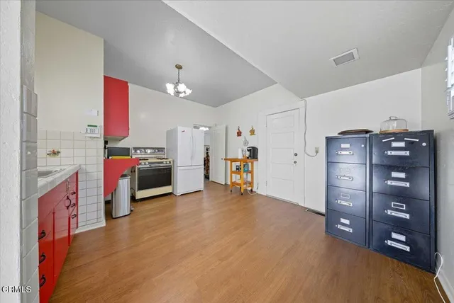 a kitchen with stainless steel appliances kitchen island granite countertop a refrigerator and a stove