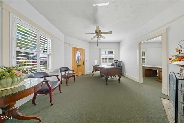 a living room with furniture and a fireplace