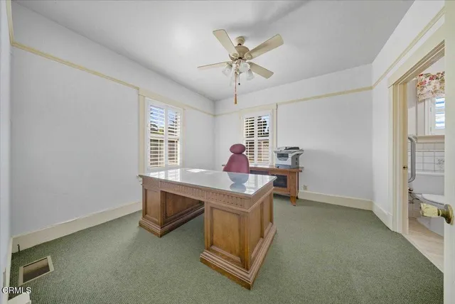 a view of workspace with furniture and window