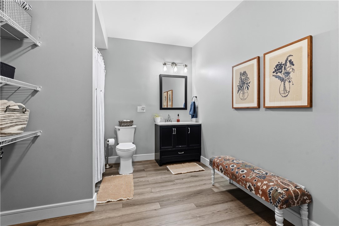 1158 Pyle Road Clarksville, OH 45113 - Photo 50 of 76 This modern bathroom features a stylish vanity, a toilet, and ample storage shelves.