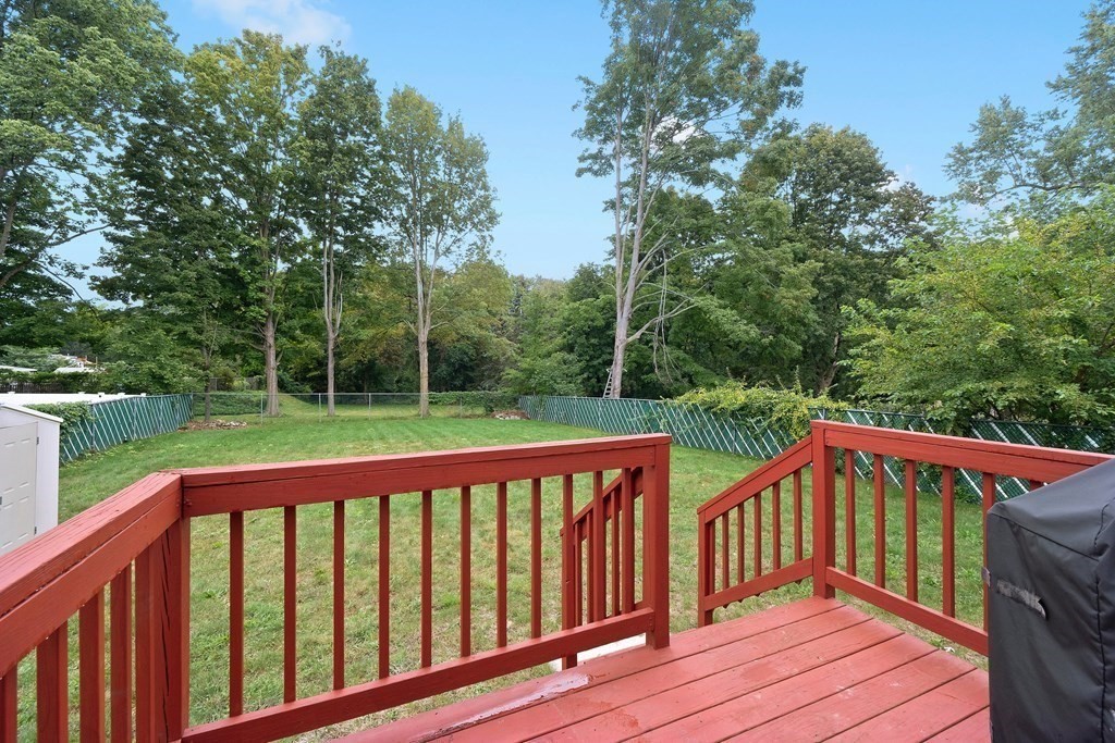 102 Orange Street Reading, MA 01867 - Photo 10 of 23 a view of a wooden deck with a large window