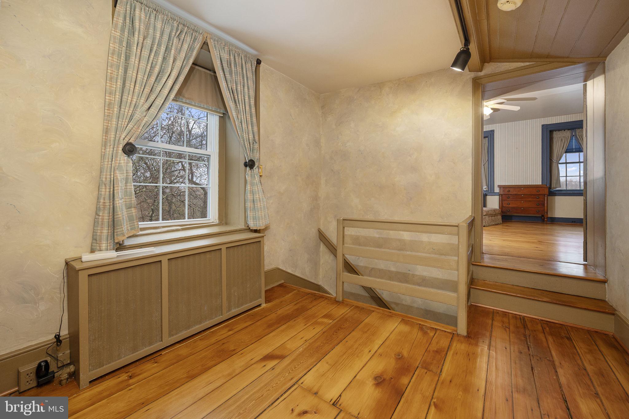 371 Old Tulpehocken Road Birdsboro, PA 19508 - Photo 43 of 99 a view of front door and bedroom with wooden floor