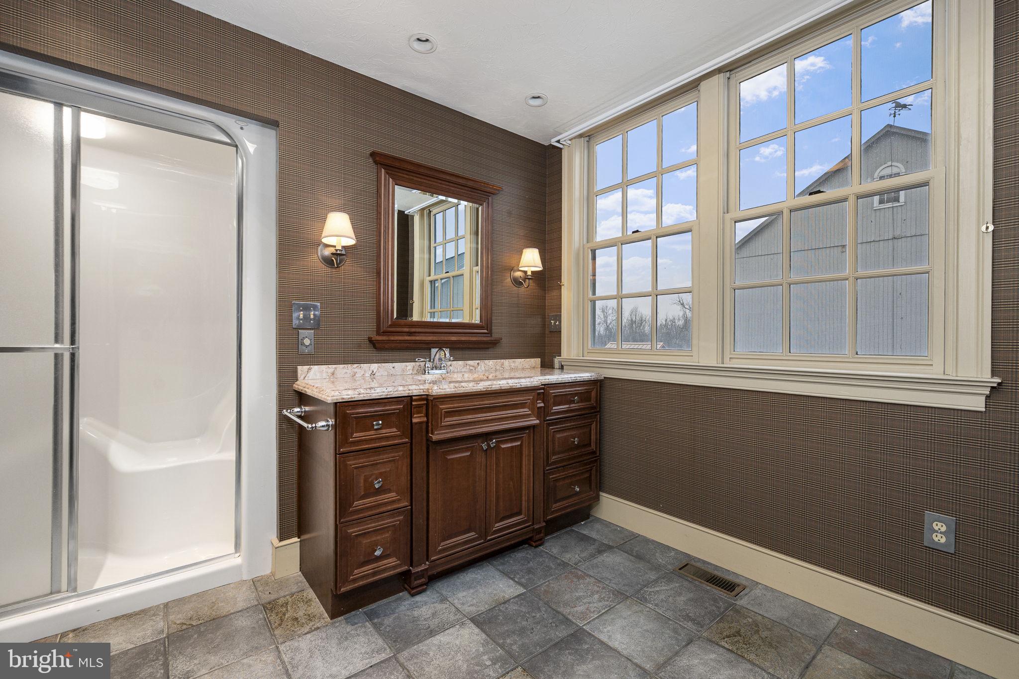 371 Old Tulpehocken Road Birdsboro, PA 19508 - Photo 62 of 99 a spacious bathroom with a granite countertop sink and a mirror