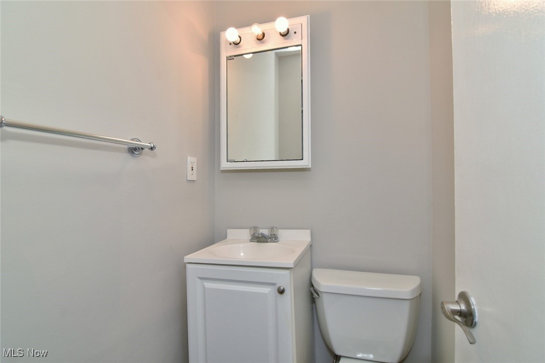 1443 Churchill Road Lyndhurst, OH 44124 - Photo 11 of 39 Half bathroom with vanity and toilet