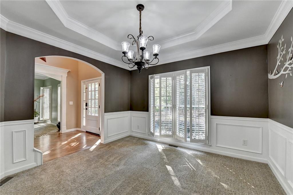 1973 Hamilton Mill Parkway Dacula, GA 30019 - Photo 13 of 105 a view of a livingroom with a chandelier curtains and large windows