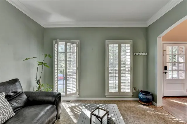 a living room with furniture or kitchen view and a wooden floor