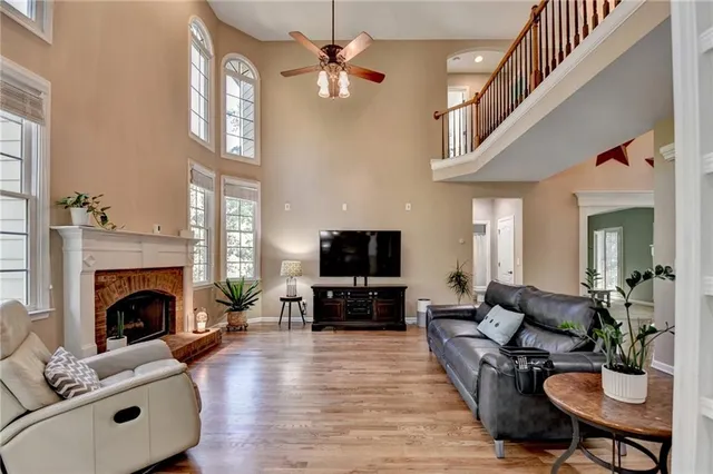 a kitchen with stainless steel appliances granite countertop a sink a stove and white cabinets