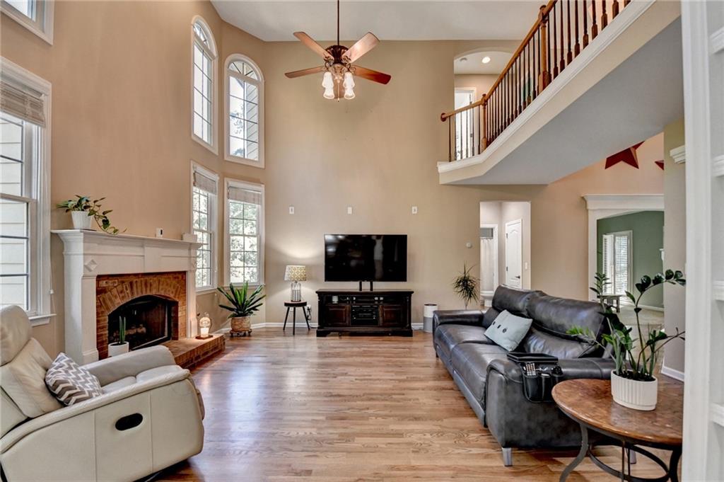 1973 Hamilton Mill Parkway Dacula, GA 30019 - Photo 23 of 105 a living room with furniture a fireplace and a flat screen tv