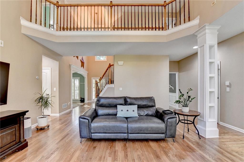 1973 Hamilton Mill Parkway Dacula, GA 30019 - Photo 25 of 105 a living room with furniture or wooden floor and a flat screen tv