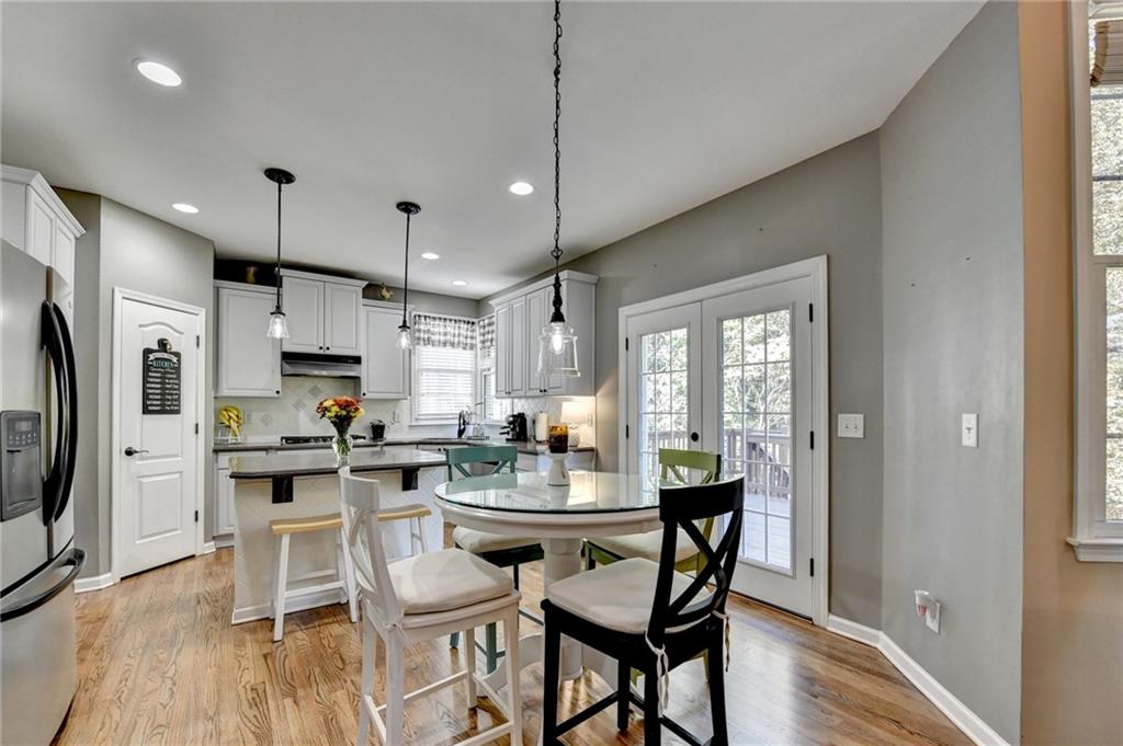 1973 Hamilton Mill Parkway Dacula, GA 30019 - Photo 28 of 105 a kitchen with a table chairs refrigerator and microwave
