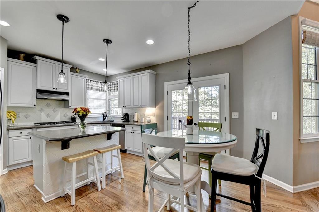 1973 Hamilton Mill Parkway Dacula, GA 30019 - Photo 30 of 105 a view of a kitchen with kitchen island dining table and a large window