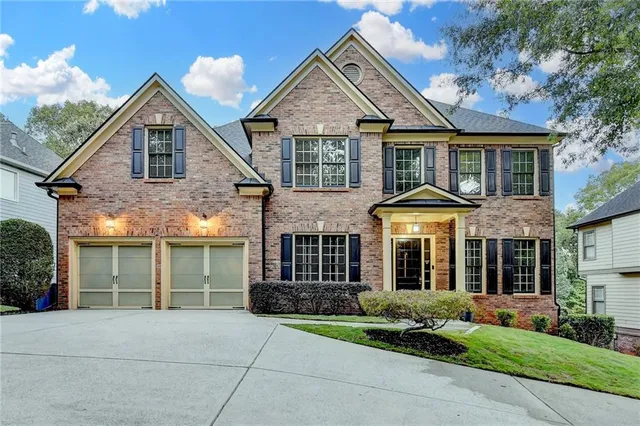 a front view of a house with a garden